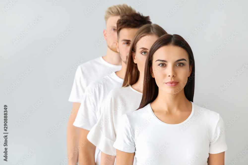 Group of young people in stylish casual clothes on light background Group of young people in stylish casual clothes on light background
