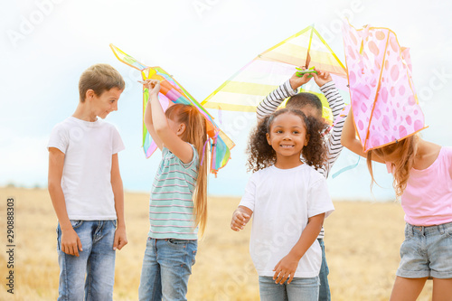 Little children flying kites outdoors