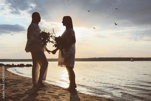 Beautiful lesbian couple on their wedding day near river photo