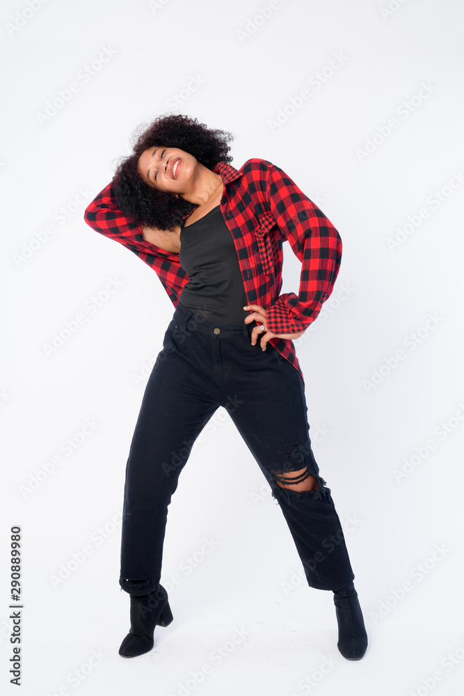 Full body shot of happy young beautiful African hipster woman posing Full body shot of happy young beautiful African hipster woman posing
