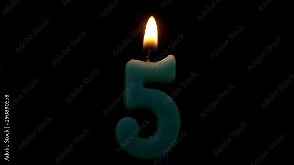 Burning birthday candle isolated on black background, number 5