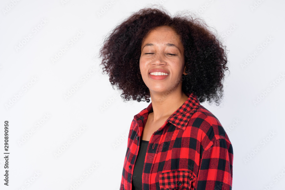 Face of happy young beautiful African hipster woman smiling with eyes closed Face of happy young beautiful African hipster woman smiling with eyes closed