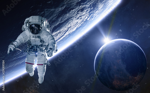 Fototapeta Naklejka Na Ścianę i Meble -  Astronaut on background of planets of deep space. Science fiction. Elements of this image furnished by NASA