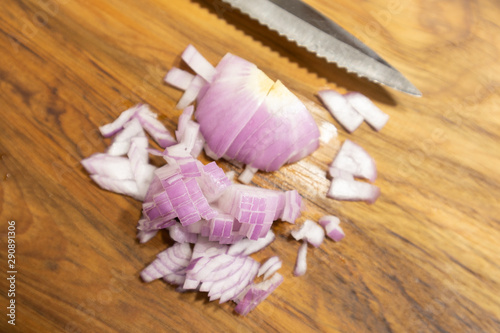 Close up Chopped red onion on the kitchen cutting board with Knife.