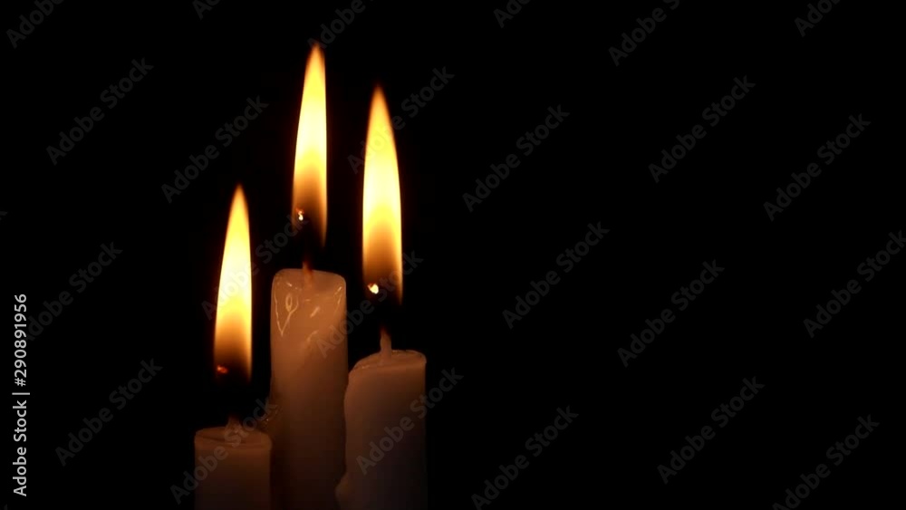 Burning candles on black with space for text. Religion, funeral and memorial concept. Burning candles on black with space for text. Religion, funeral and memorial concept.