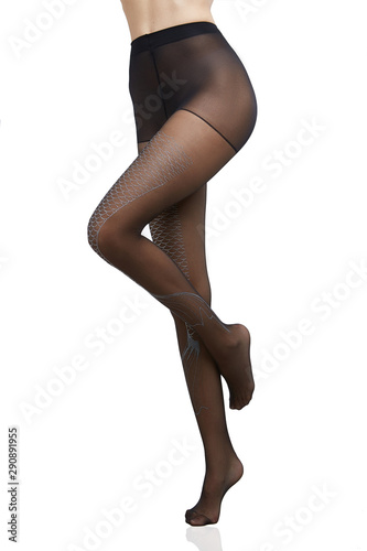 Cropped bottom shot of a female figure in black transparent tights with mermaid tail pattern. The fashion model bent one of her knees.