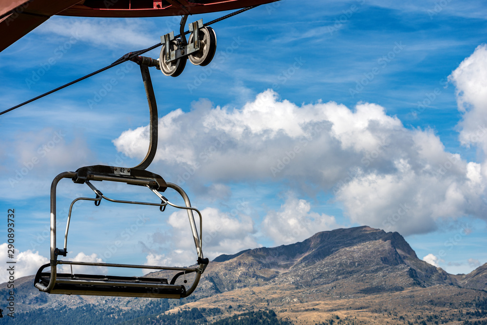 Close-up of a empty chairlift with steel cables in mountain, Italian Alps, Passo Rolle,Trentino Alto Adige, Italy, south Europe Close-up of a empty chairlift with steel cables in mountain, Italian Alps, Passo Rolle,Trentino Alto Adige, Italy, south Europe