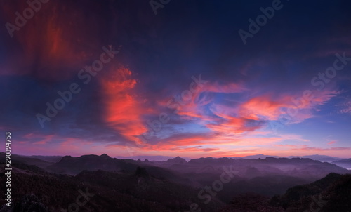 Mountain view panorama morning of red clouds moving above top hills with blue sky background, twilight at Ban Ja Bo Hill Tribes Village, Pang Mapla, Mae Hong Son, northern of Thailand.