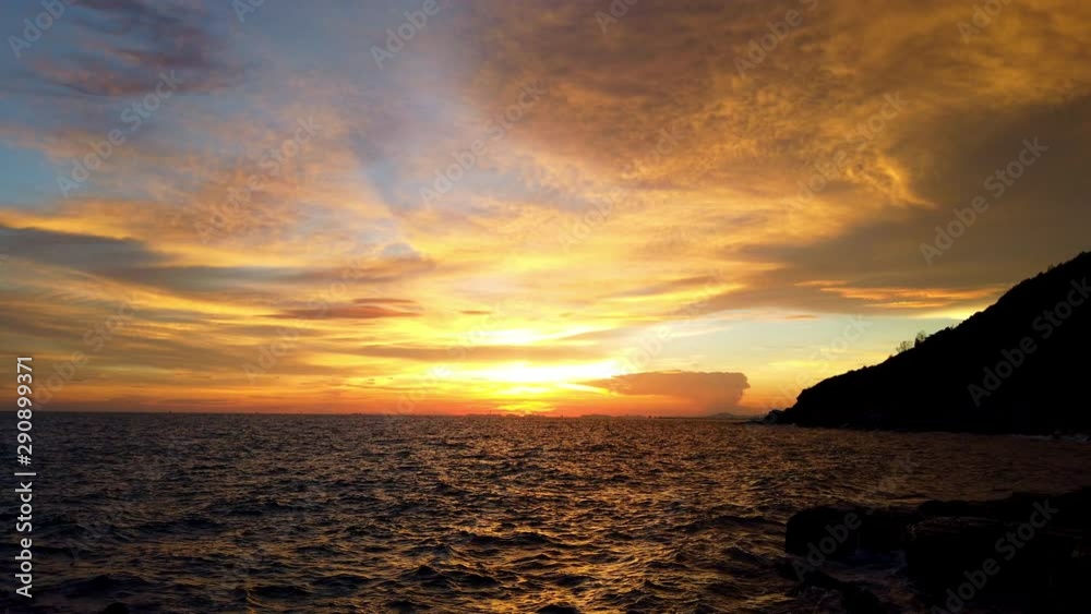 4K Landscape wide shot of sea waves splashing against tropical island rocky coastline seashore and cliff in summer sunset with twilight sky. 4K Landscape wide shot of sea waves splashing against tropical island rocky coastline seashore and cliff in summer sunset with twilight sky.