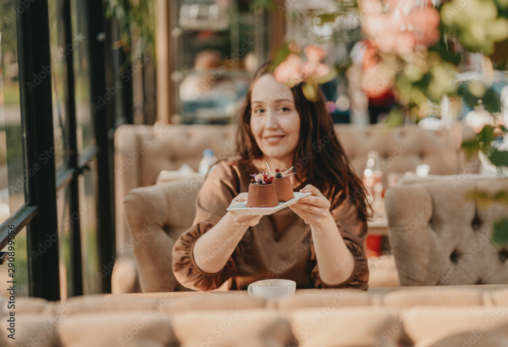 custom made wallpaper toronto digitalCharming brunette woman with long curly hair sitting at window in cafe with dessert in hands, selective focus
