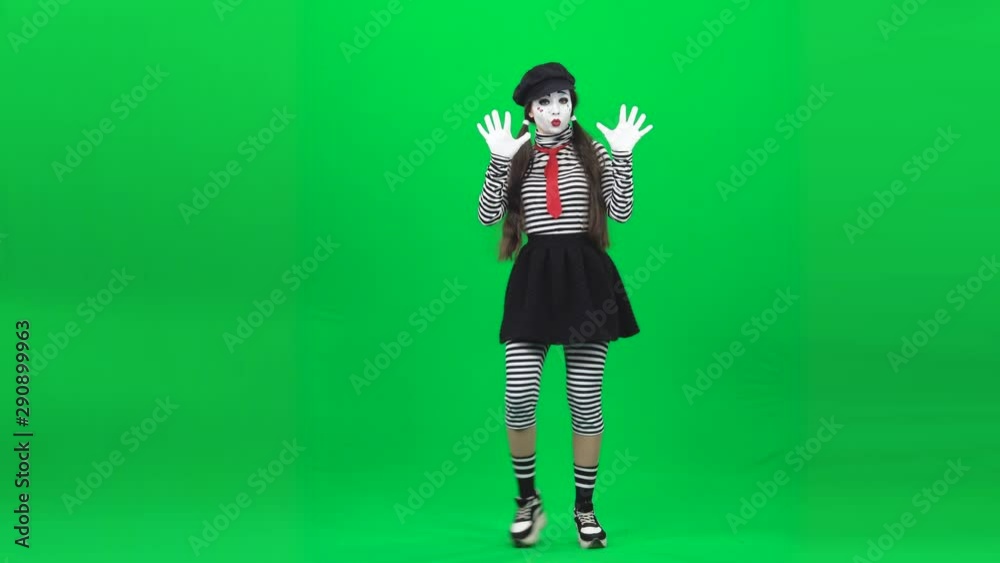 Mime girl is dancing behind an invisible glass. Chroma key. Mime girl is dancing behind an invisible glass. Chroma key.