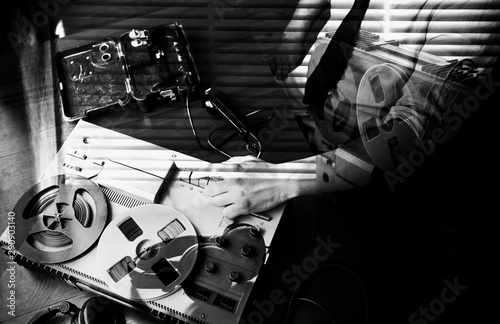Special agent speaks on field telephone set USSR. Officer wiretapping   on the reel tape recorder. KGB spying conversations. Black and white photo.