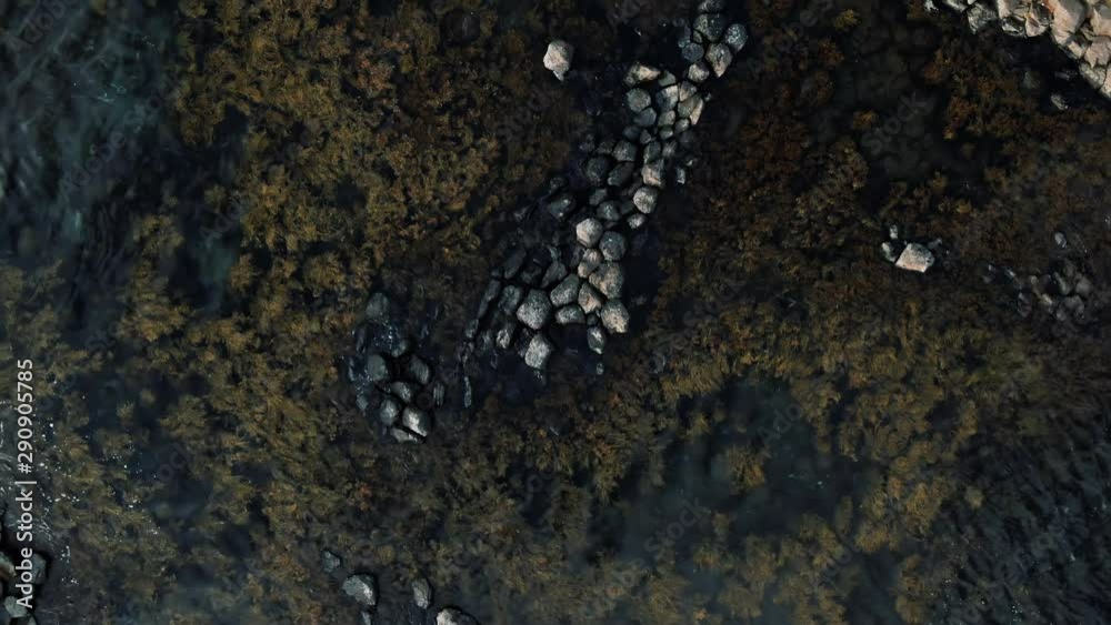 Aerial top down ascending view of volcanic basalt formation on the sea in West Iceland Aerial top down ascending view of volcanic basalt formation on the sea in West Iceland