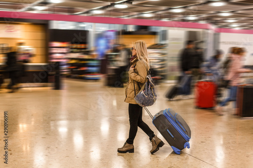 Woman traveler tourist walking with luggage at train station. Active and travel lifestyle concept © Angelov