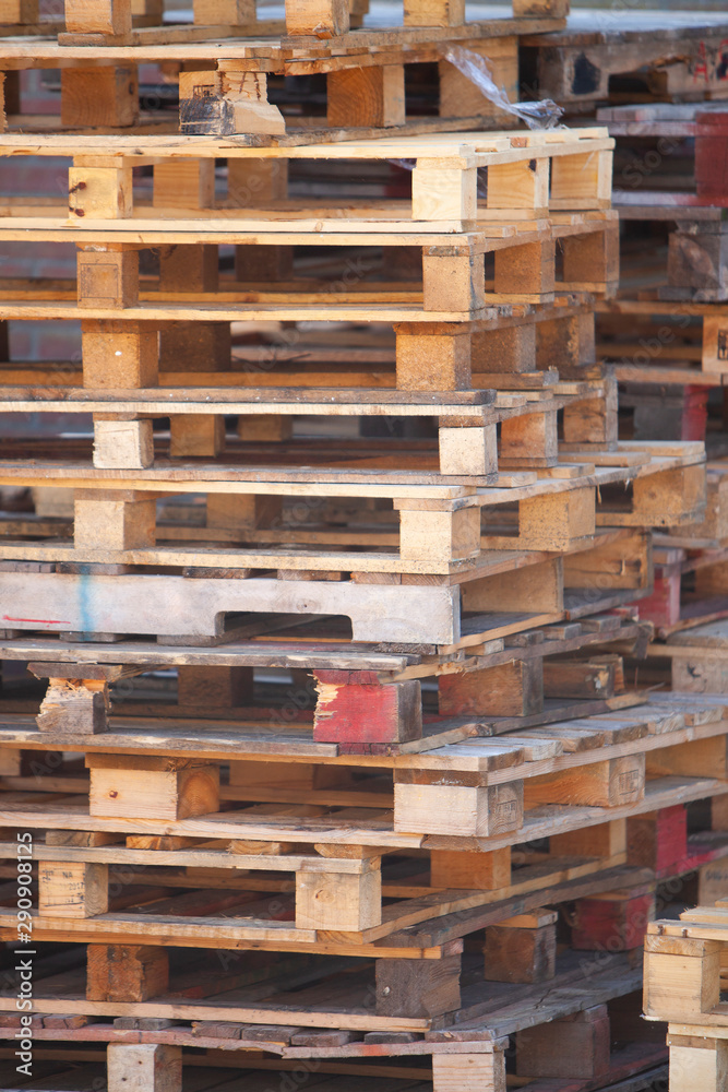 closeup of pile of empty wooden pallets