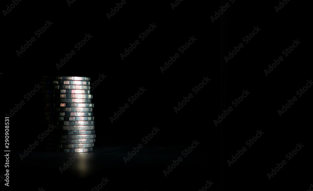 Thai ten baht coins stacked on a black background Thai ten baht coins stacked on a black background