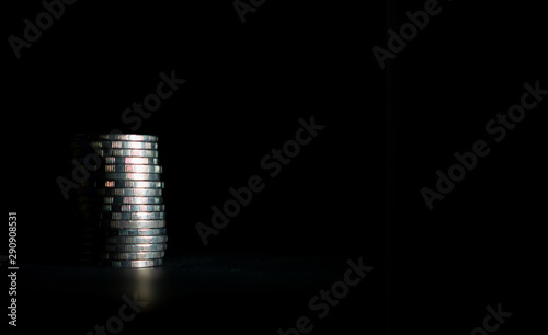 Thai ten baht coins stacked on a black background