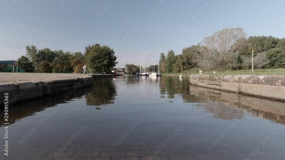 British canal waterway. Transparent water revealing old brick flooring under marina channel. Peaceful scenic, sunny tourist walk. British canal waterway. Transparent water revealing old brick flooring under marina channel. Peaceful scenic, sunny tourist walk.