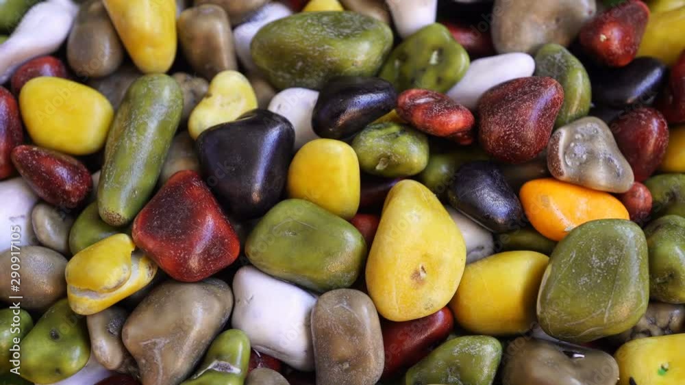 Rotating colored chocolate-glazed pebbles with filling. Rotating colored chocolate-glazed pebbles with filling.