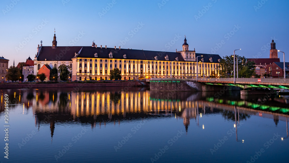 View of University of Wroclaw, Odra River and University Bridge in Wroclaw at sunrise. 