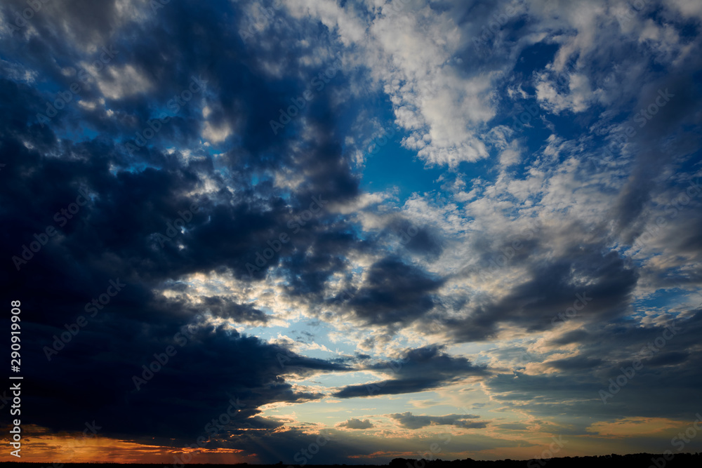 Beautiful sunset - dark sky with clouds and sunlight Beautiful sunset - dark sky with clouds and sunlight
