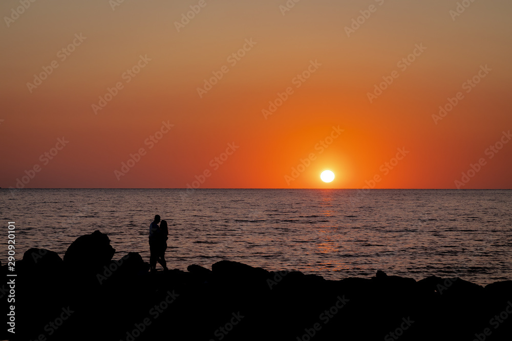 sunset. sunset sea. Silhouettes of a hugging couple in love. sunset. sunset sea. Silhouettes of a hugging couple in love.