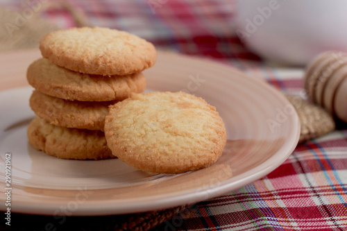 Round sweet cookies. Delicious dessert with high sugar and carbohydrate suitable for eating with milk and tea or coffee on color and white background with colorful placemat