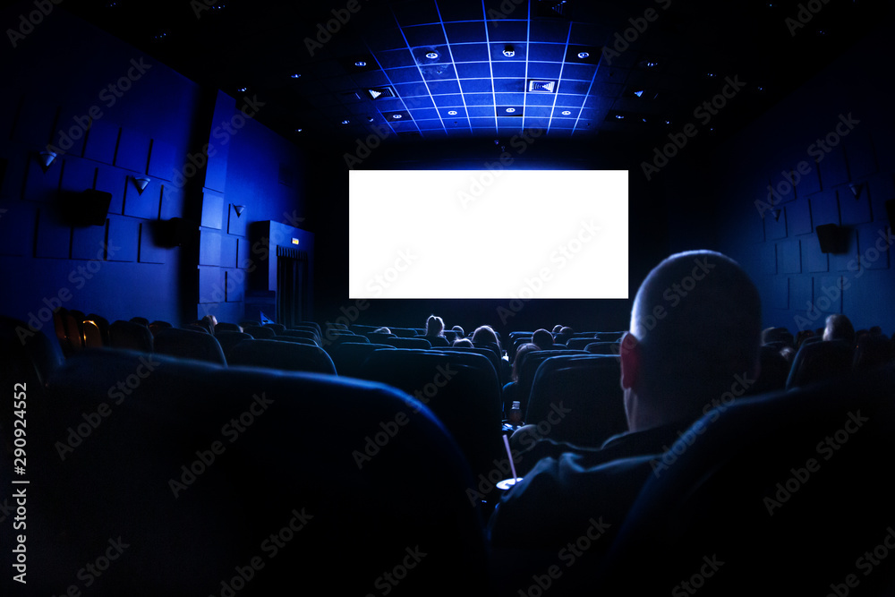 Cinema or theater in the auditorium. people watching a movie. Mockup with white blank screen