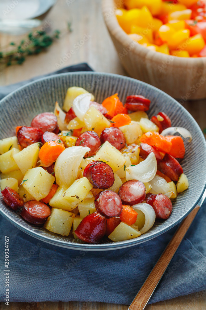 Roasted sausages with vegetables like potato, onion and carrot. Easy fast recipe for dinner or lunch. Roasted sausages with vegetables like potato, onion and carrot. Easy fast recipe for dinner or lunch.