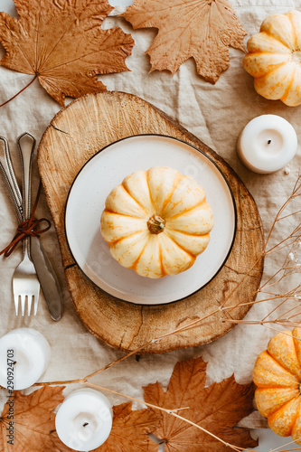 Top view of small pumpkins on a wooden board decorated Autumn ornate. The concept of Thanksgiving and Fall time. photo