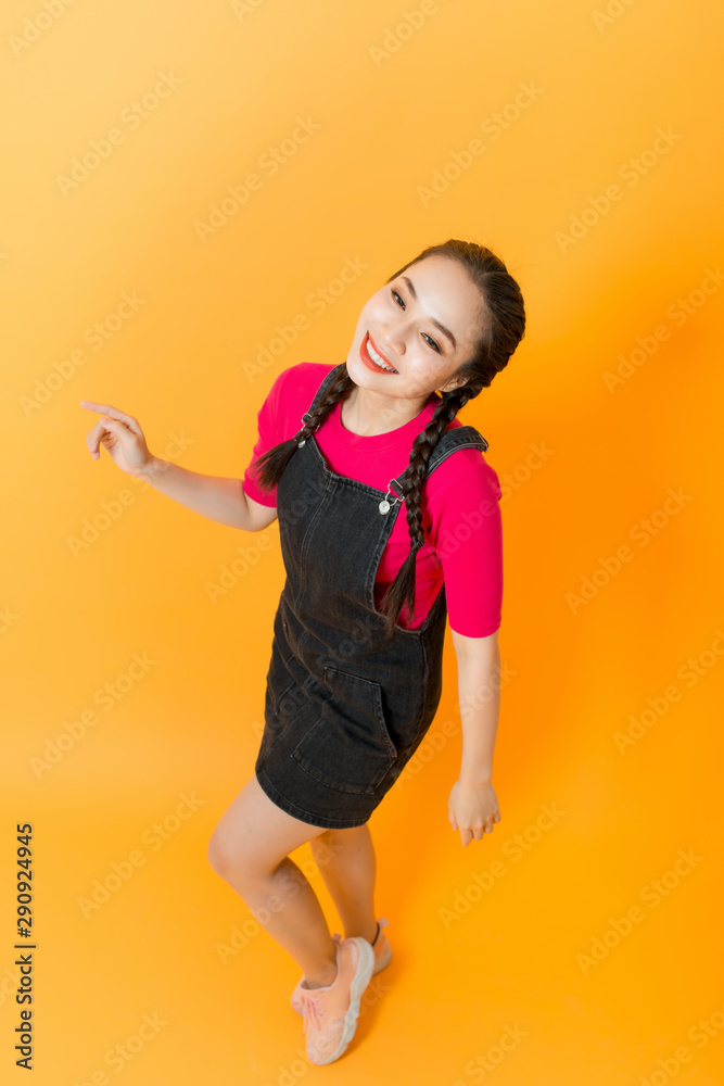 happy young woman isolated on yellow background happy young woman isolated on yellow background