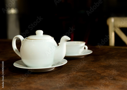 White porcelain tea cup and teapot, English tea on table, Afternoon Tea