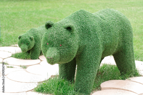 Statue of an animal made of grass in a park. Bear in the park © Євген Малюга