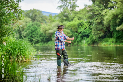 Get hooked. fisherman with fishing rod. summer weekend. Big game fishing. retired bearded fisher. Trout bait. hobby and sport activity. pothunter. mature man fly fishing. man catching fish