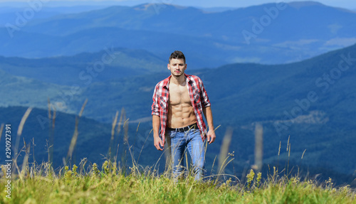 free spirit. man on mountain landscape. camping and hiking. cowboy in hat outdoor. countryside concept. farmer on rancho. travelling adventure. hipster fashion. sexy macho man in checkered shirt