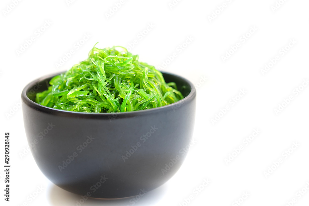 Hiyashi Wakame Chuka or seaweed salad in black bowl on white background ,Japanese food Hiyashi Wakame Chuka or seaweed salad in black bowl on white background ,Japanese food