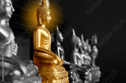 Gold Buddha statue with color and focus, decorated with Aura light of Buddha's head for beauty