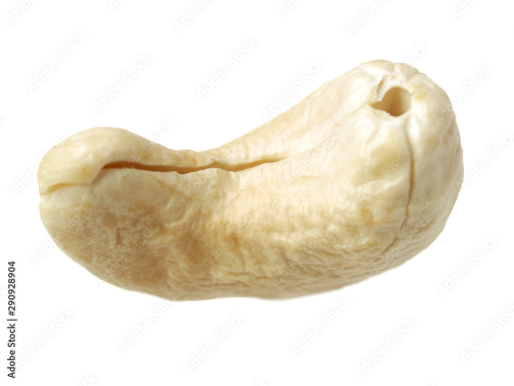 One cashew on white background close-up macro. One cashew on white background close-up macro.