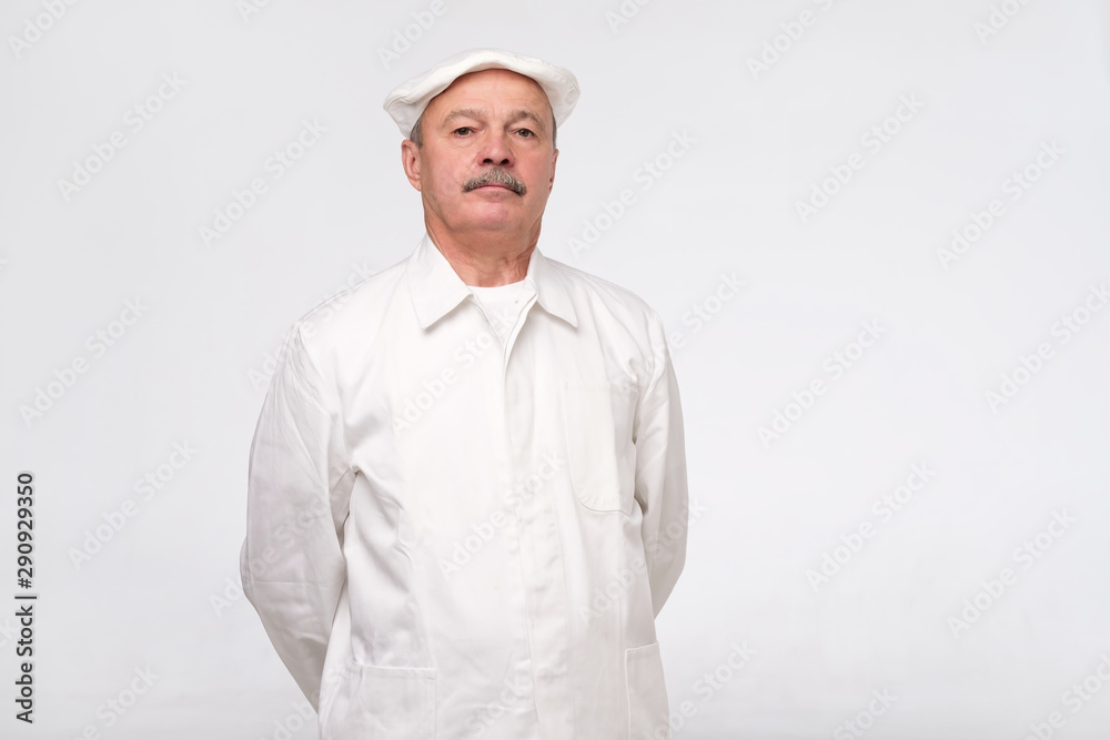 Mature hispanic chef looking confident isolated over white background. Experienced man is happy to cook for you. Mature hispanic chef looking confident isolated over white background. Experienced man is happy to cook for you.