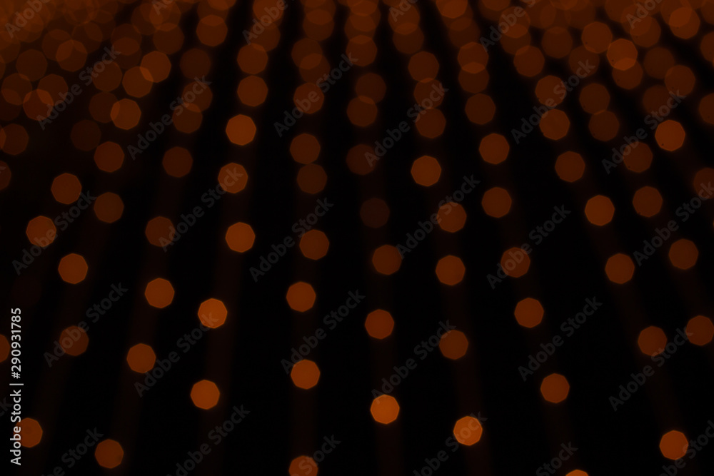 abstract orange illumination from unfocused garland decor object winter holidays dark background concept picture 