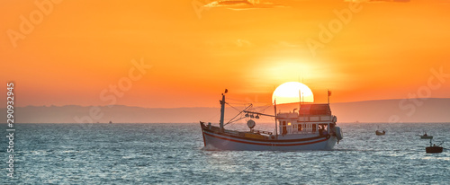 Sea landscape at sunset when fishing boats out to sea to harvest fish end the day. photo