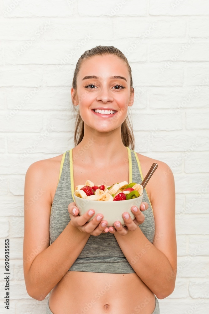 Young caucasian sporty woman holding a cereal bowl Young caucasian sporty woman holding a cereal bowl