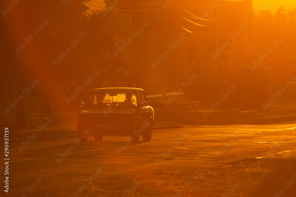 Obraz premium old soviet car is driving down the road