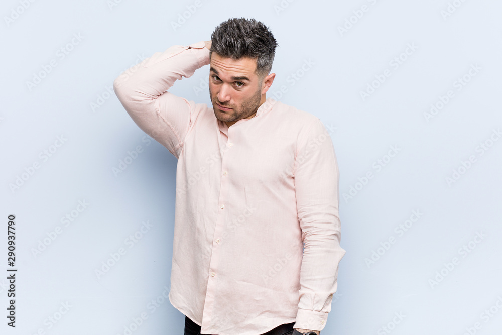 Young handsome cool man touching back of head, thinking and making a choice. Young handsome cool man touching back of head, thinking and making a choice.