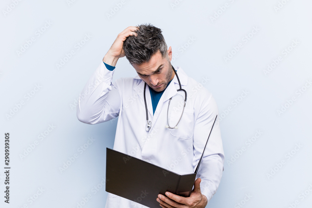 Caucasian doctor man holding a folder being shocked, she has remembered important meeting. Caucasian doctor man holding a folder being shocked, she has remembered important meeting.