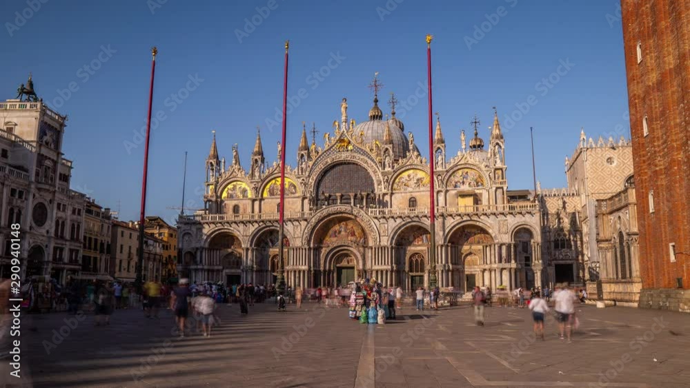 Basilica of St Mark timelapse hyperlapse and San Marco campanile. It is cathedral church of Roman Catholic Archdiocese of Venice. It lies at Piazza San Marco. Tourists walking in front of it. Venice