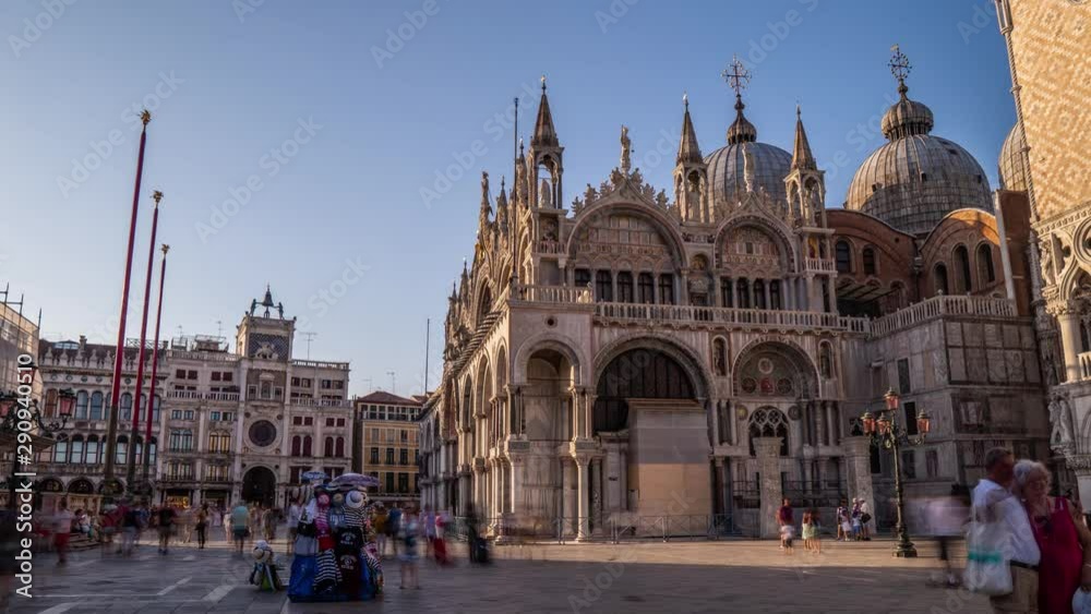 Basilica of St Mark timelapse hyperlapse and San Marco campanile. It is cathedral church of Roman Catholic Archdiocese of Venice. It lies at Piazza San Marco. Tourists walking in front of it. Venice