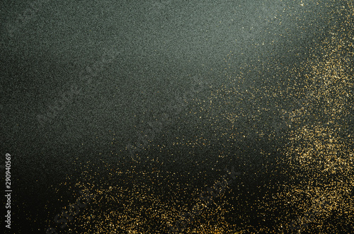 Golden sparkles on black background. Festive concept. - Image