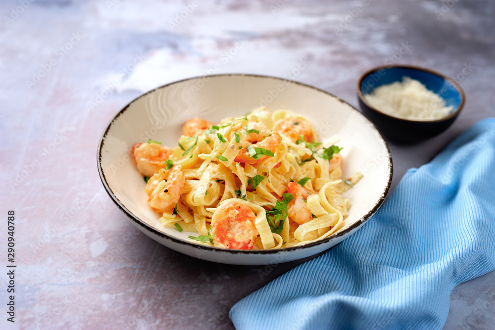 Tasty creamy shrimp fettuccine alfredo with parmesan Tasty creamy shrimp fettuccine alfredo with parmesan
