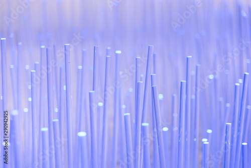 Futuristic fantastic background with many small glass rods and purple beams